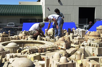 The crew constructs a miniature Tatooine city.